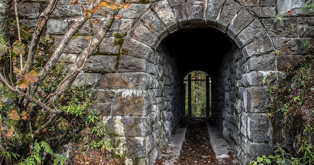 The tunnel is constructed of locally sourced stone and features an ornate archway on either side (stock photo)