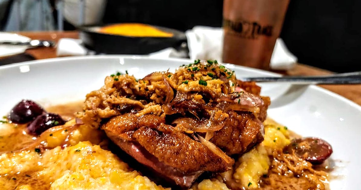 The Duck Breast features Mossy Creek Mushrooms, Grapes, Shallots and Pencil Cob Grits