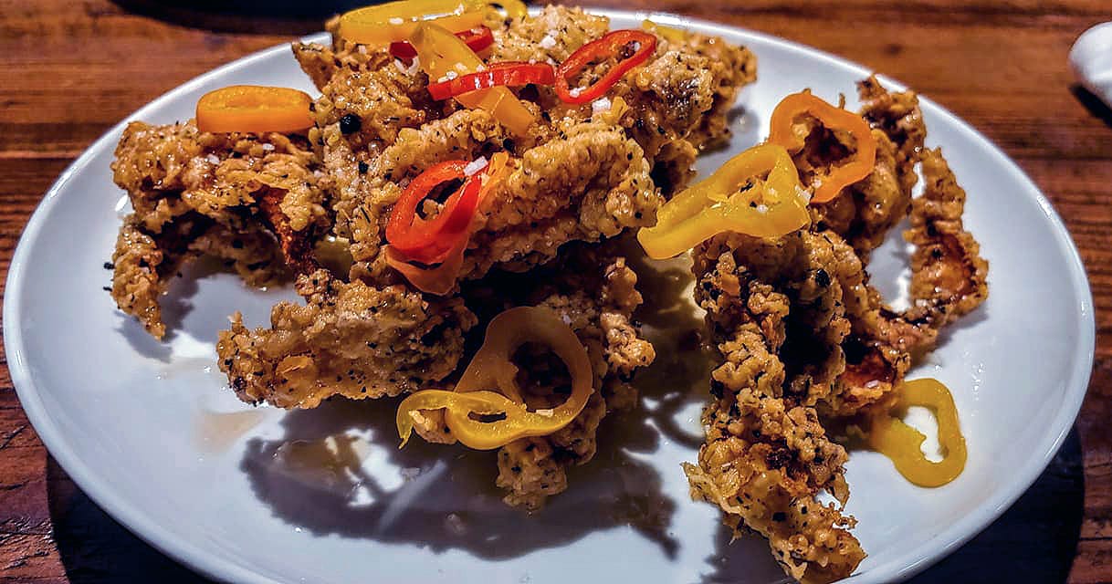 The Fried Chicken Skins are served with local honey, smoked west virginia sea salt and pickled lunchbox peppers